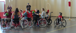 Children and youth playing wheelchair basketball.
